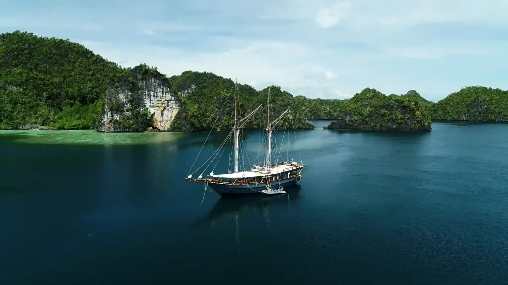 Phinisi anchored among the karst islands of Raja Ampat