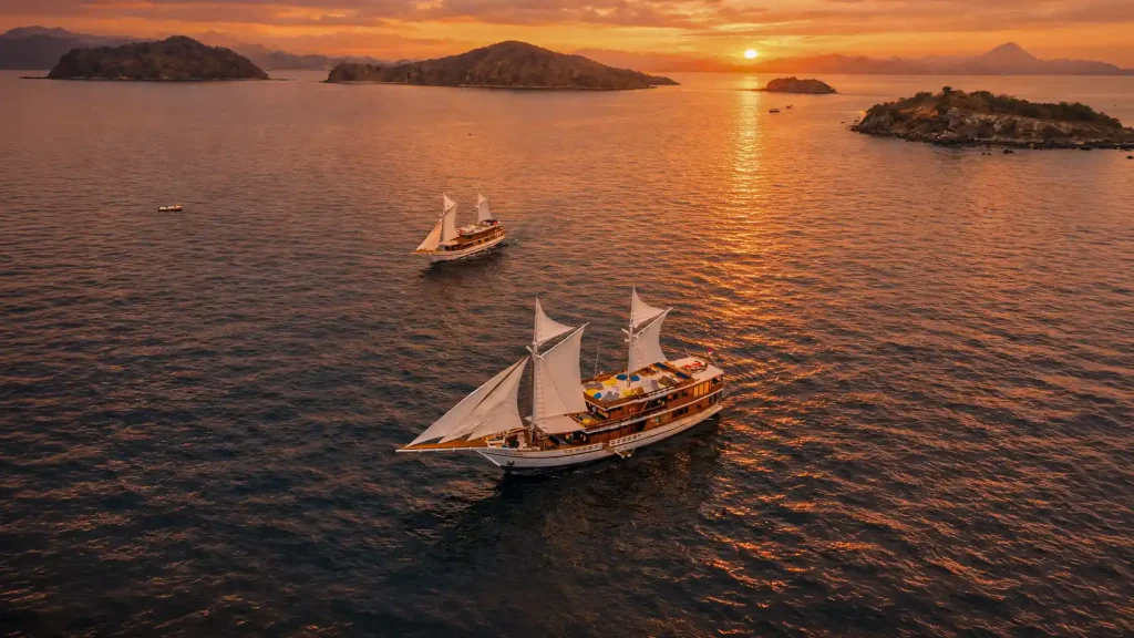 Phinisi sailing at sunset in Komodo waters