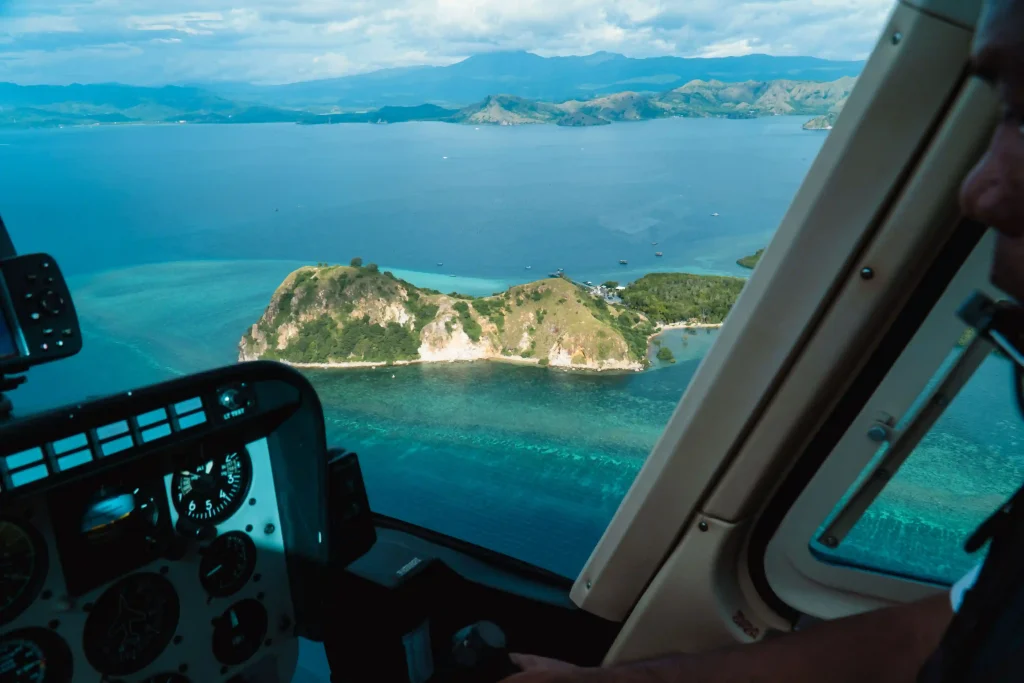 View from a helicopter cockpit over islands between Labuan Bajo and Sumba