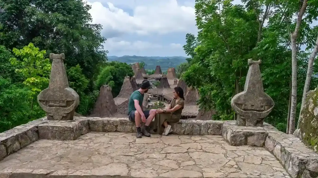 Visitors resting among the stone graves of Prai Ijing Village