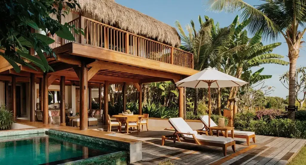 Thatched wooden villa with a private pool and loungers in Sumba