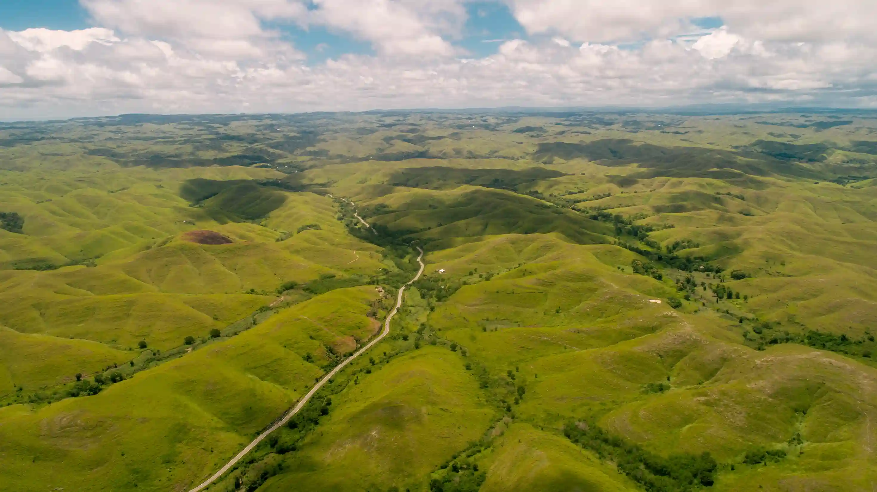 Wide green landscape of Tanau Hill