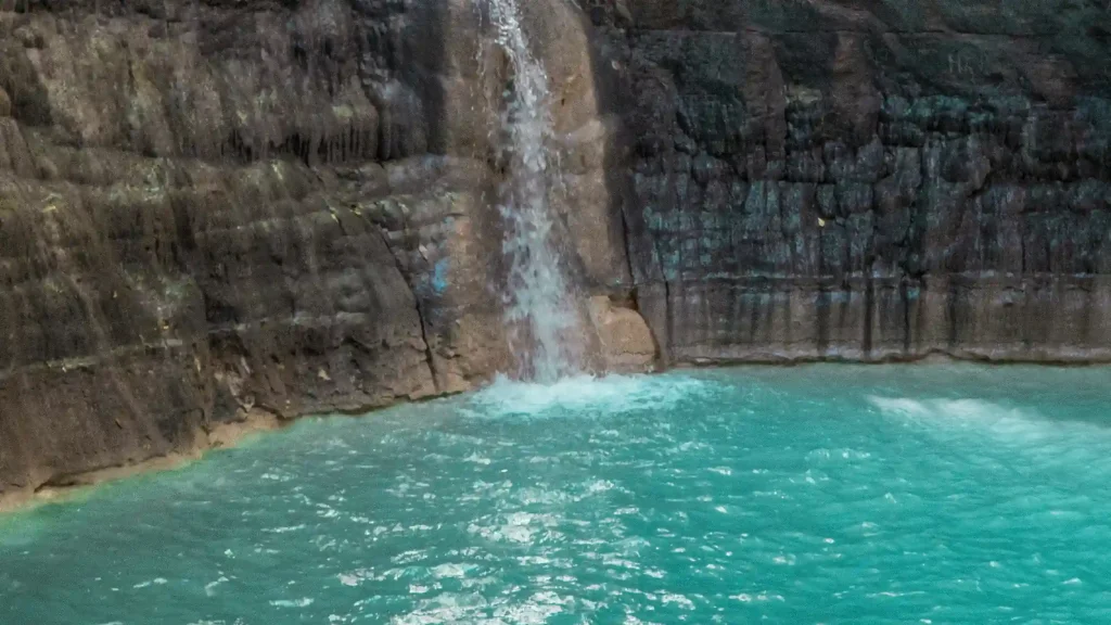 Waimarang Waterfall falling into a blue pool